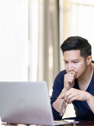 person-watching-webinar-on-laptop